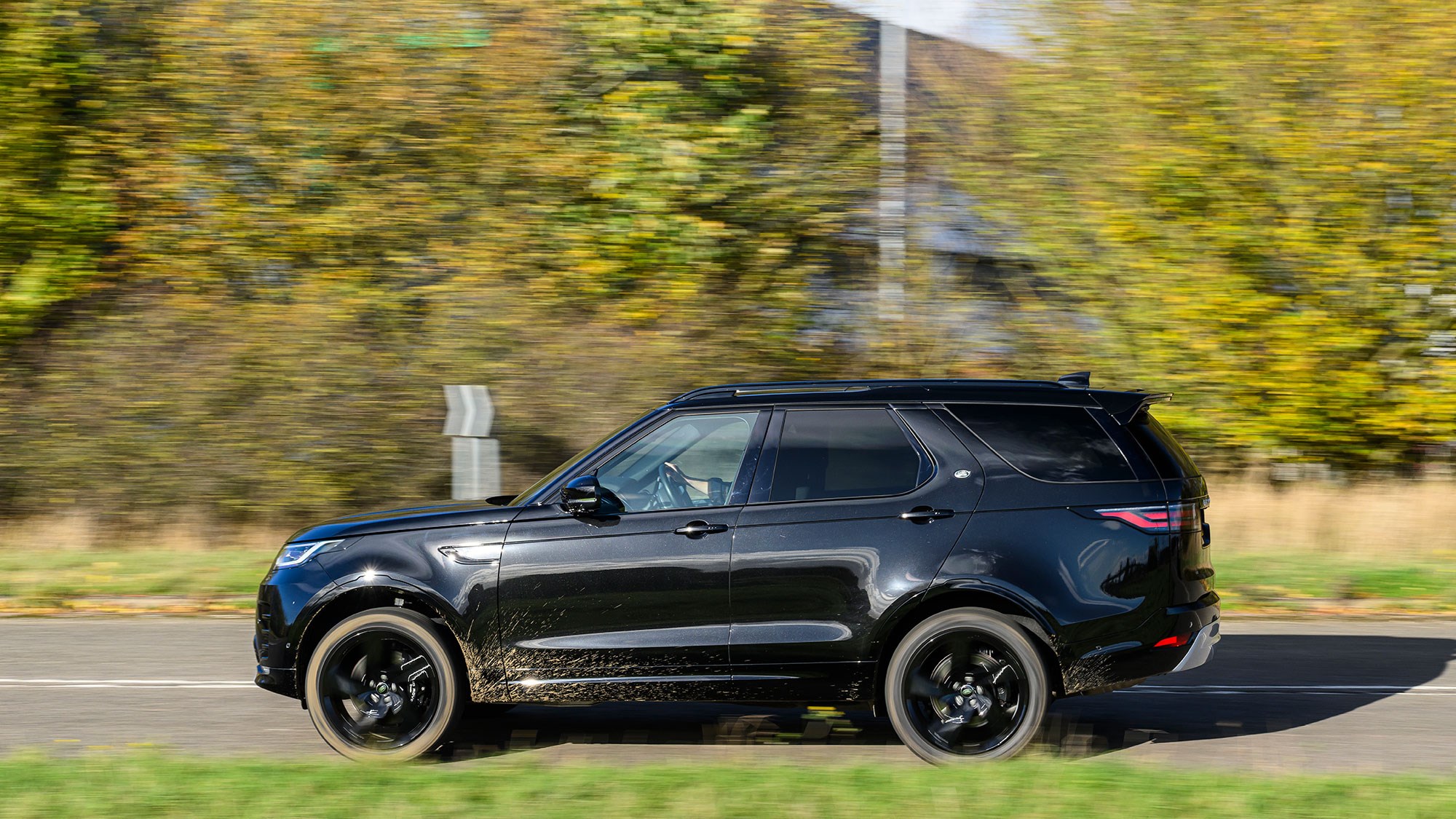 Land Rover Discover (2025) review: side view driving, black paint