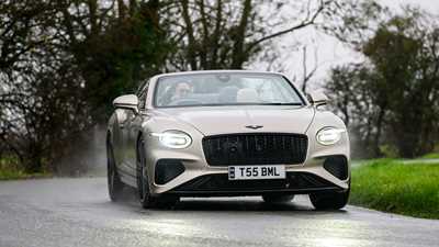 Bentley Continental GT Convertible (2025) review: front three quarter cornering, beige paint, roof down