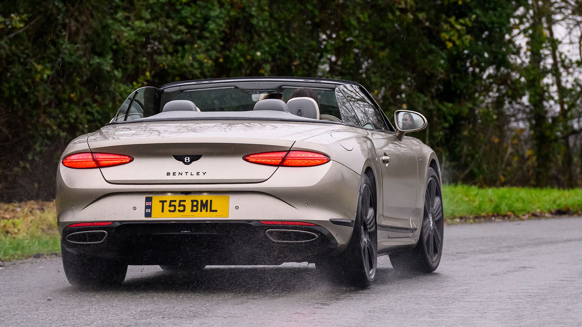 Bentley Continental GT Convertible (2025) review: rear three quarter cornering, beige paint, roof down