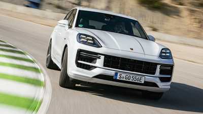 Porsche Cayenne E-Hybrid review - 2023-facelift - Turbo E-Hybrid, white, front, driving round corner on racing circuit