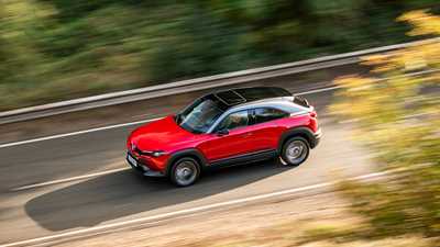 Red 2021 Mazda MX-30 driving